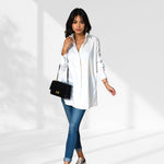 woman wearing a white  oversized shirt dress facing forward showcasing the fit and style.