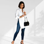 woman wearing a  white oversized shirt dress facing forward showcasing the fit and style.