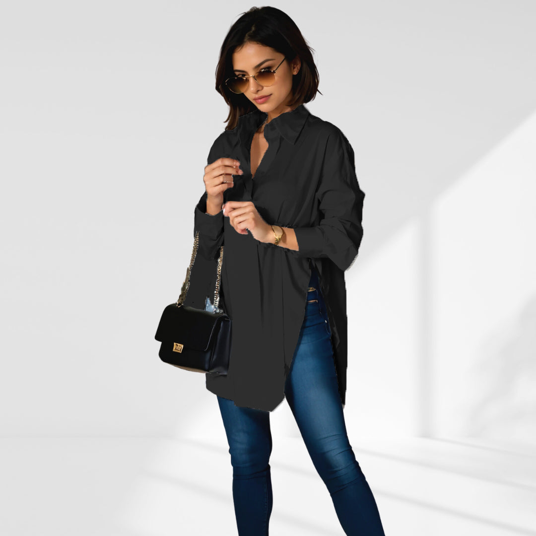 woman wearing a black oversized shirt dress facing forward showcasing the fit and style.