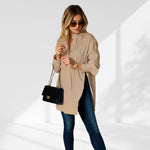 woman wearing a beige oversized shirt dress facing forward showcasing the fit and style.