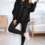 woman wearing a oversized snap fit black hoodie facing forward showcasing the fit and style.