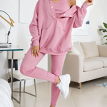 woman wearing a oversized snap fit pink hoodie facing forward showcasing the fit and style.