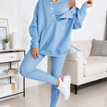 woman wearing a oversized snap fit blue hoodie facing forward showcasing the fit and style.