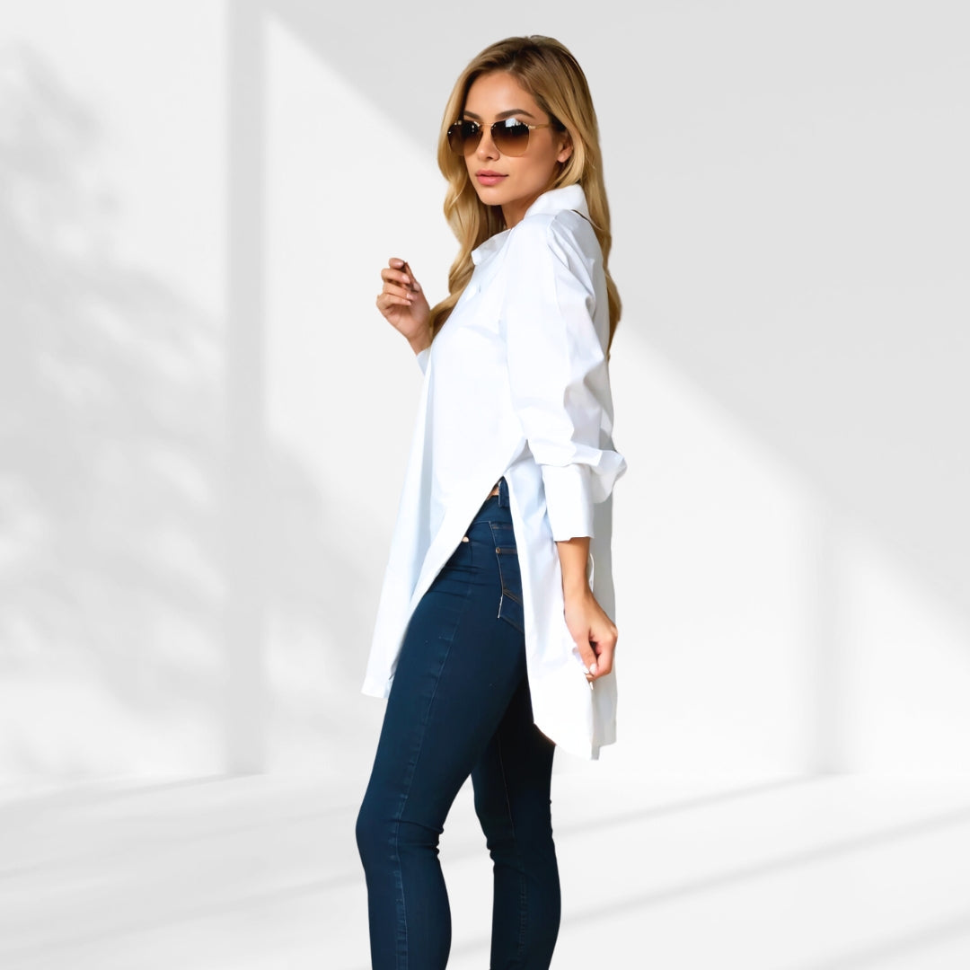 woman wearing a white oversized shirt dress facing forward showcasing the fit and style.