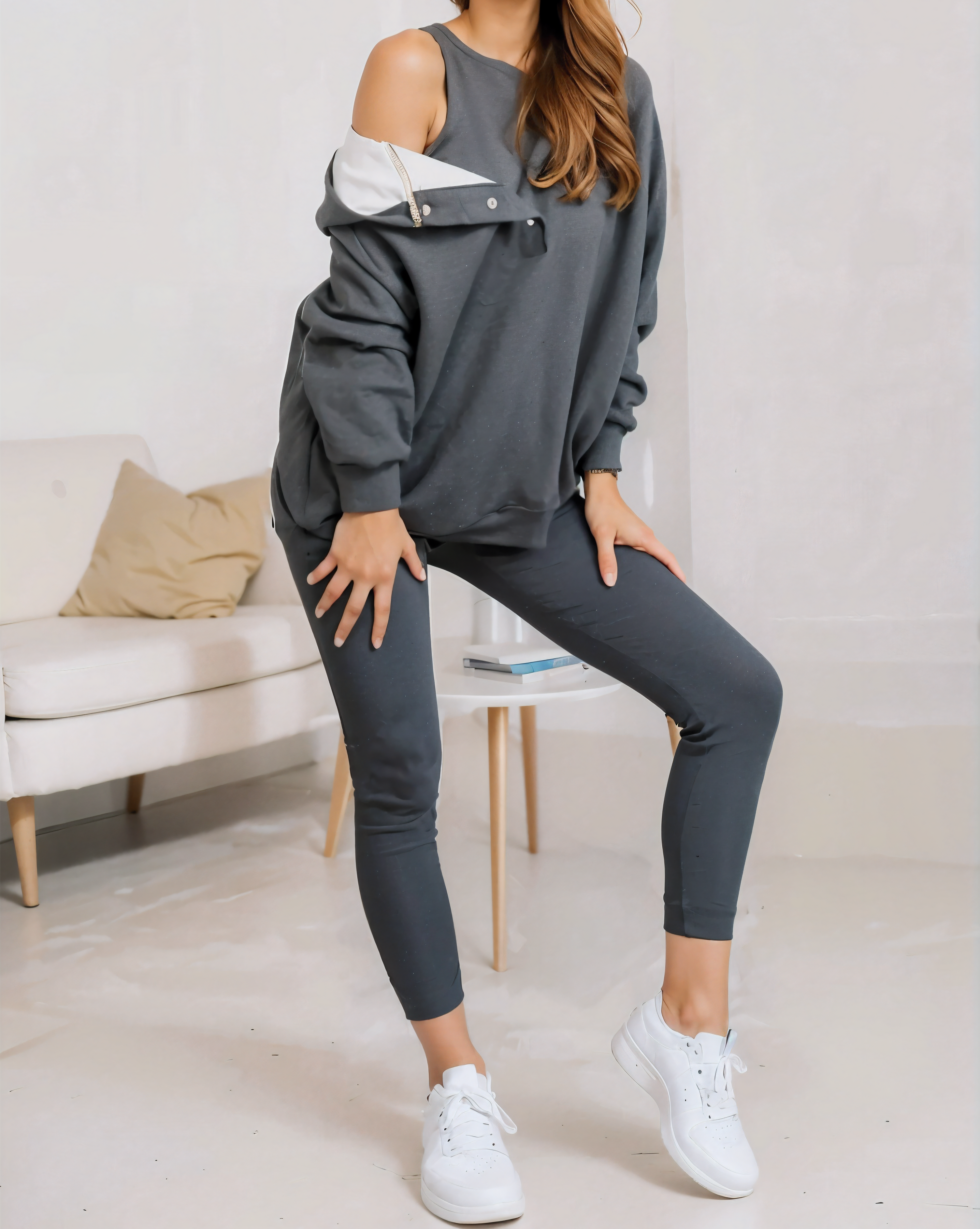 woman wearing a oversized snap fit gray hoodie facing forward showcasing the fit and style.