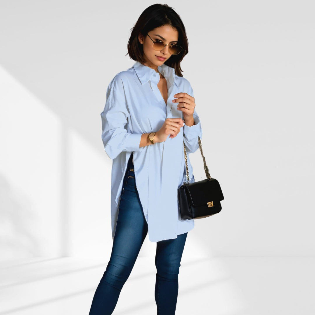 woman wearing a  blue oversized shirt dress facing forward showcasing the fit and style.